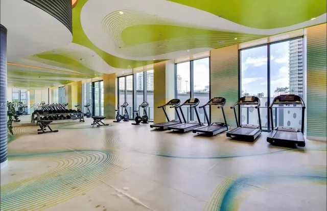 a view of a gym room with gym equipment