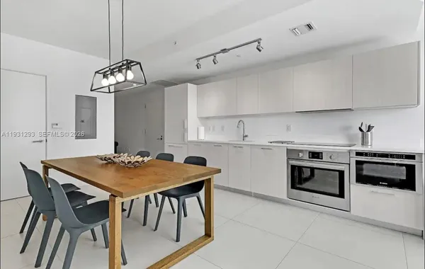 a view of kitchen with sink dining table and chairs