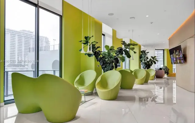 a view of a dining room with furniture and a potted plant
