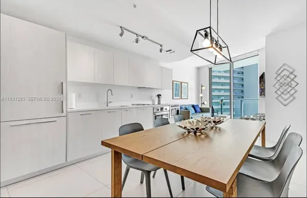 a view of a dining room with furniture and a chandelier