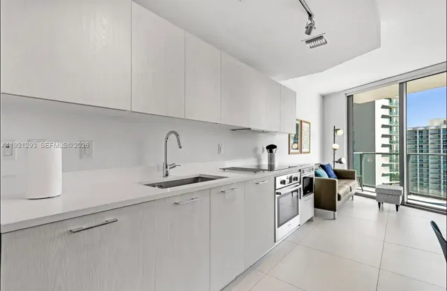 a kitchen with a sink stove and cabinets