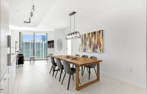 a dining room with furniture and window