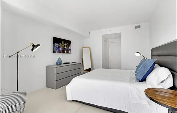 a bed room with a bed and a chair