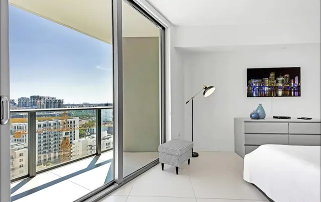 a very nice looking room with a large window and a glass door