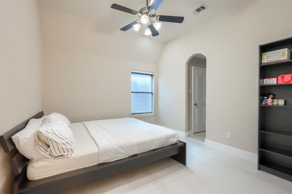 2246 Longview Road Irving, TX 75063 - Photo 32 of 40 Light-toned interior with a ceiling fan, recessed lighting, arched doorway, and built-in shelving