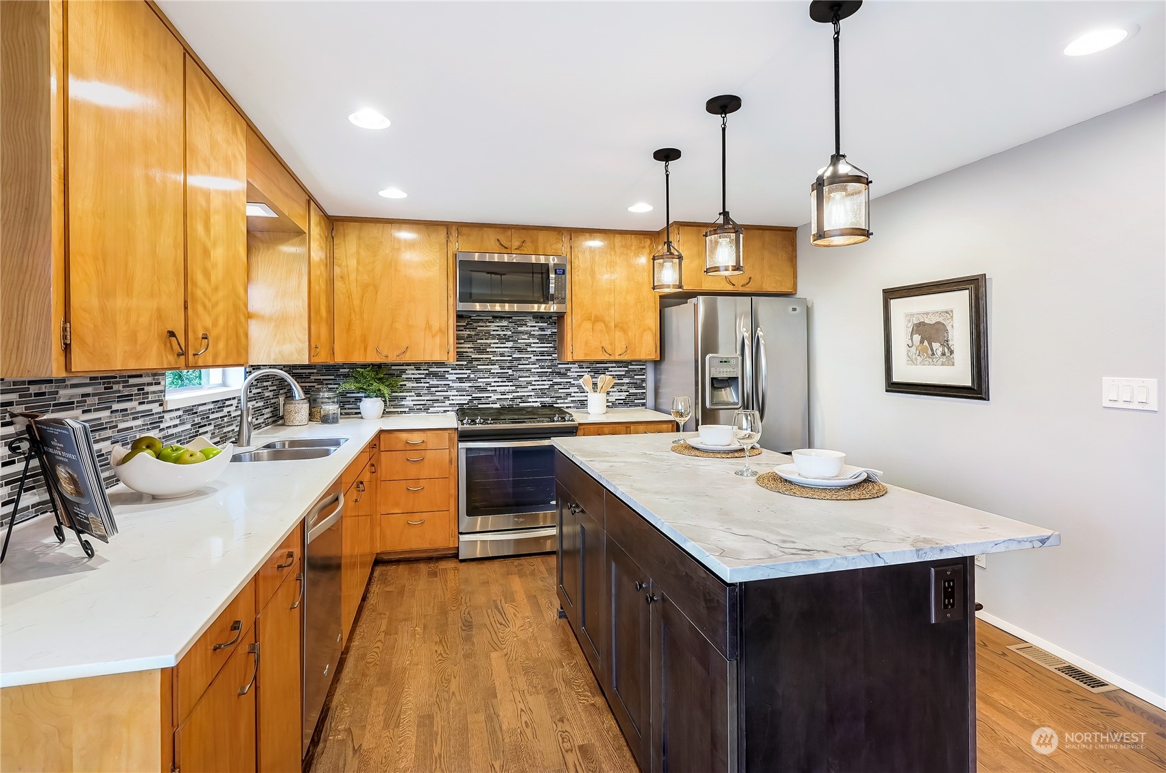3112 Talbot Road South Renton, WA 98055 - Photo 11 of 29 a kitchen with kitchen island granite countertop a sink a counter top space and living room view