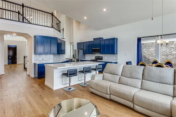 a living room with furniture and kitchen view
