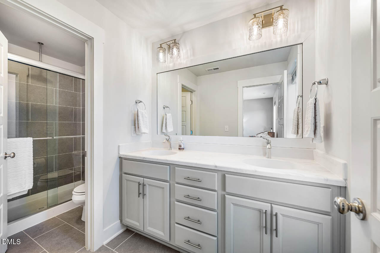 2311 Great Ridge Parkway Chapel Hill, NC 27516 - Photo 23 of 57 a bathroom with a double vanity sink and mirror