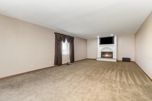 a view of empty room with a fireplace