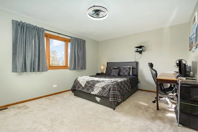 a bedroom with a bed and a table