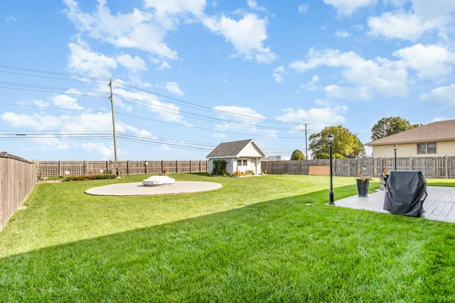 a view of a house with backyard and a garden