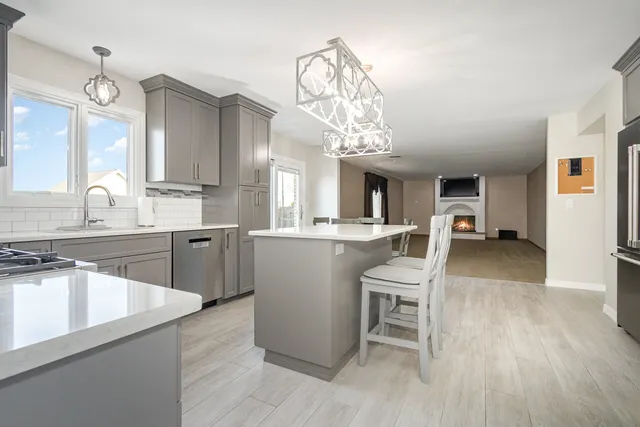 a large kitchen with a table and chairs
