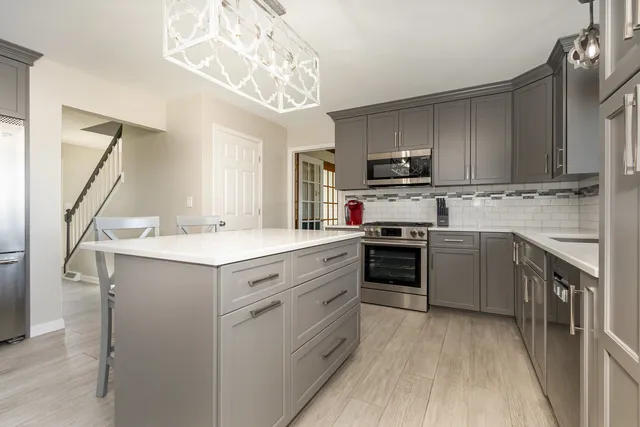 a kitchen with a sink cabinets and stainless steel appliances