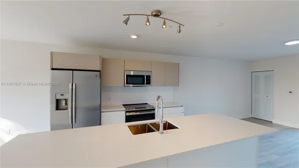 a kitchen with a refrigerator and a sink