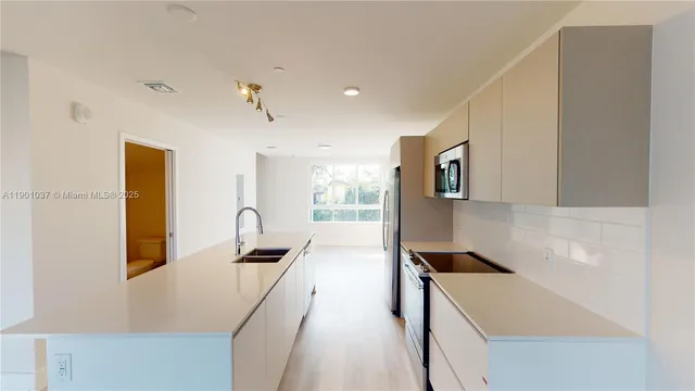 a kitchen that has a sink and a stove in it