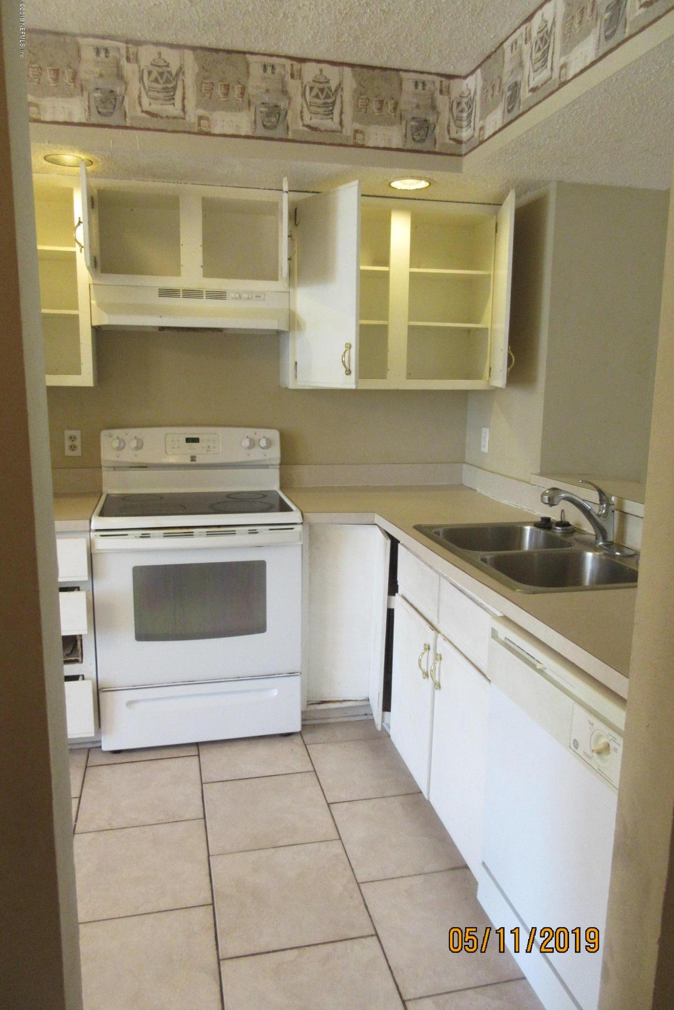 2465 Spring Vale Road Jacksonville, FL 32246 - Photo 3 of 11 a kitchen with a stove and a sink