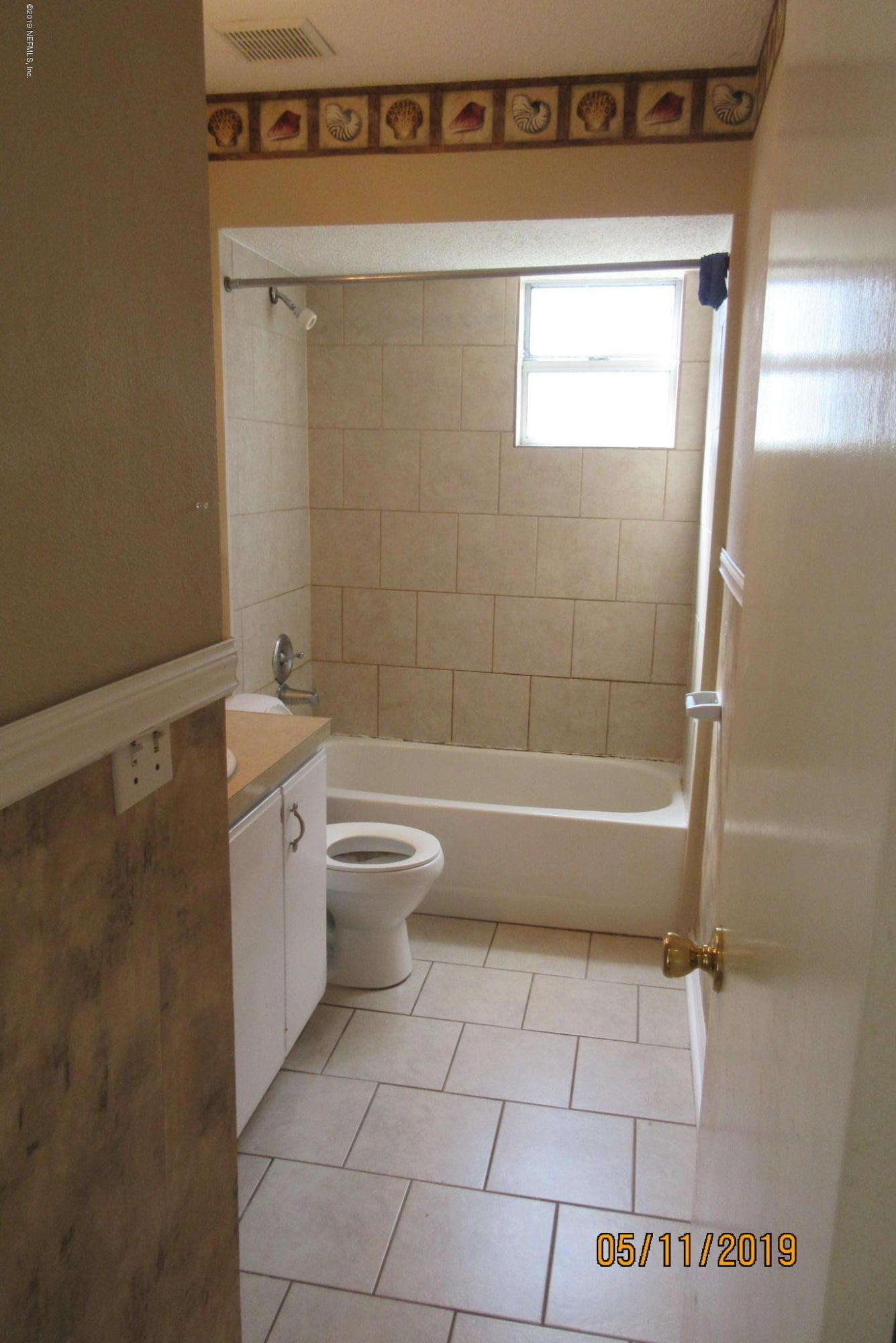 2465 Spring Vale Road Jacksonville, FL 32246 - Photo 7 of 11 a bathroom with a bathtub and toilet