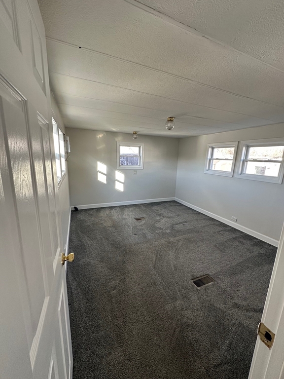 165 Newbury Street, Unit 2 Peabody, MA 01960 - Photo 7 of 8 an empty room with windows