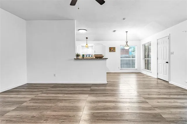 a view of a kitchen with wooden floor