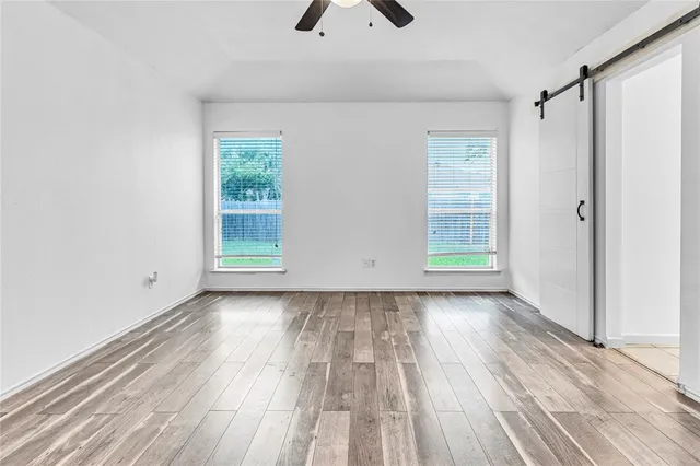 wooden floor in an empty room with a window