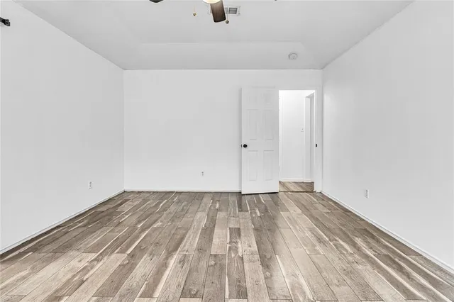 a view of a room with wooden floor