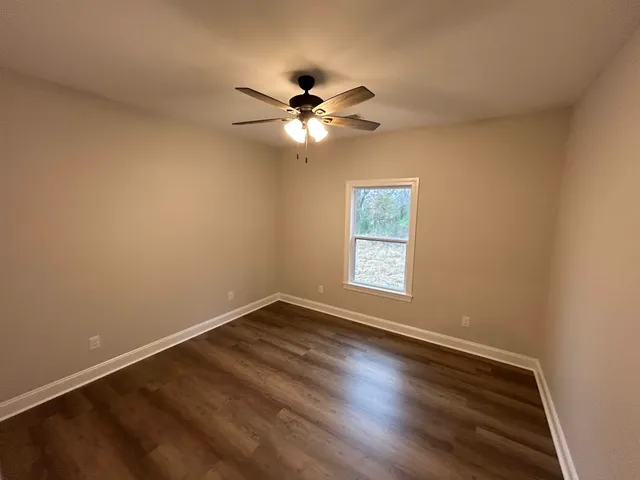 a view of room with window and ceiling fan