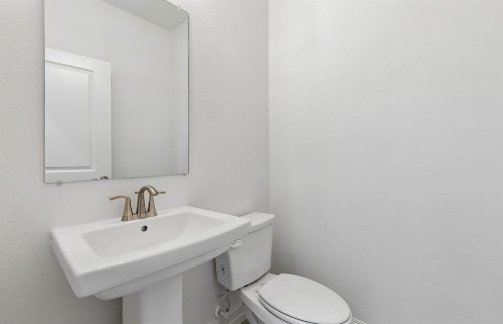 11220 Abbotsbury Road Fort Worth, TX 76052 - Photo 19 of 32 a bathroom with a sink a toilet and mirror