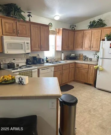 a kitchen with a sink a stove and cabinets