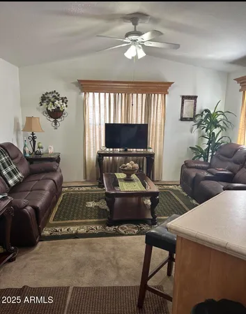 a living room with furniture and a chandelier
