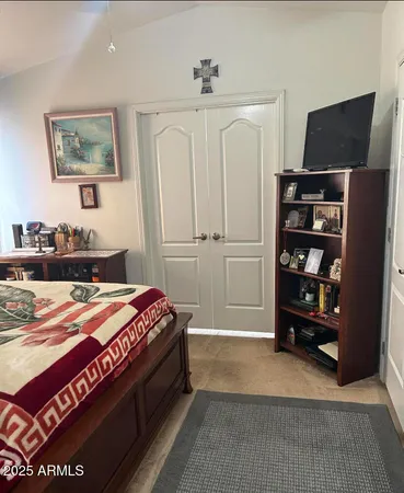 a spacious bedroom with a bed and a television in it