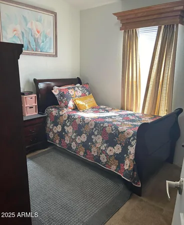 a bed sitting in a bedroom next to a window