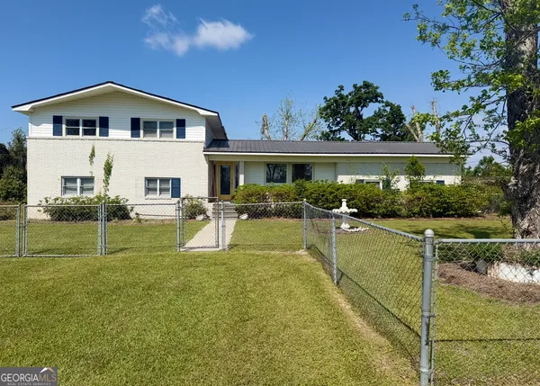 a view of a house with swimming pool yard and outdoor seating