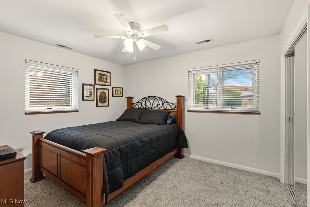 6753 Mill Road Brecksville, OH 44141 - Photo 21 of 34 Bedroom with light carpet, a ceiling fan, and a closet