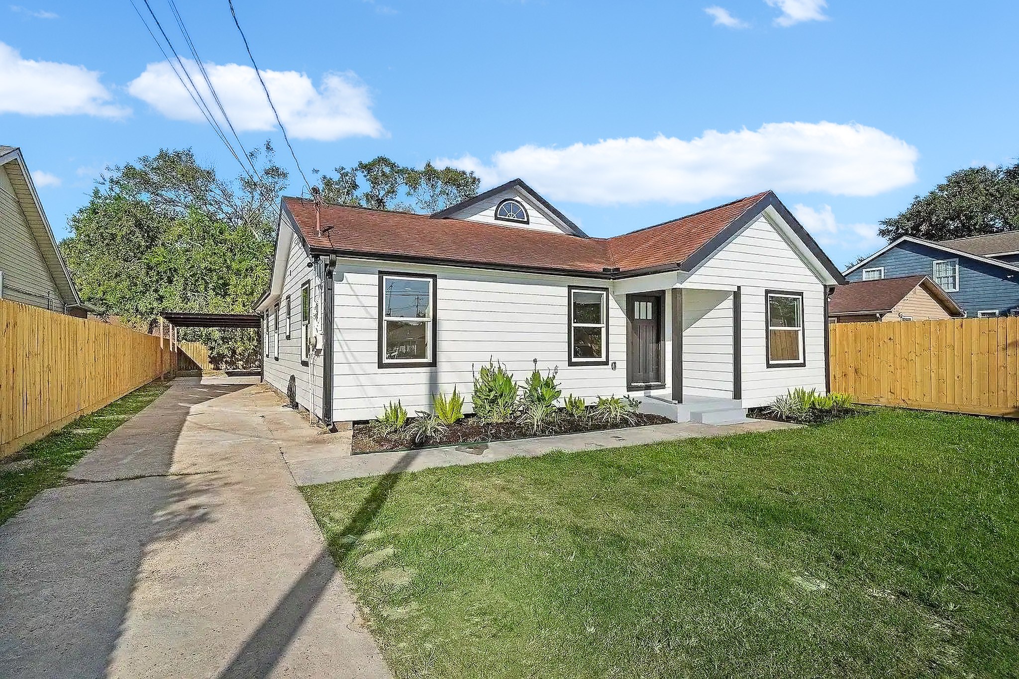 6305 Gay Street Houston, TX 77022 - Photo 2 of 13 a front view of a house with a garden and yard