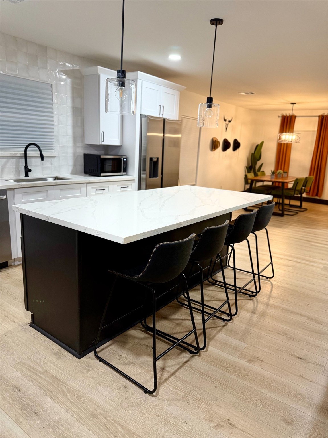 6305 Gay Street Houston, TX 77022 - Photo 8 of 13 a kitchen with refrigerator cabinets and wooden floor