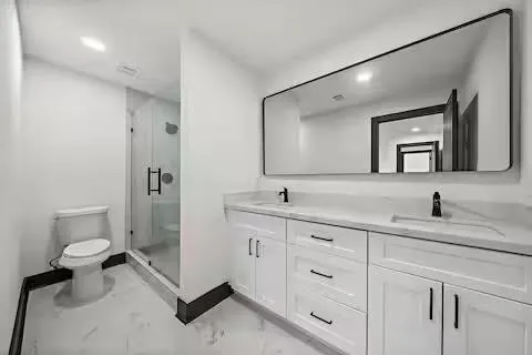 a bathroom with a toilet sink and mirror