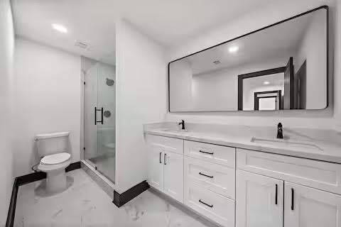 6305 Gay Street Houston, TX 77022 - Photo 9 of 13 a bathroom with a toilet sink and mirror