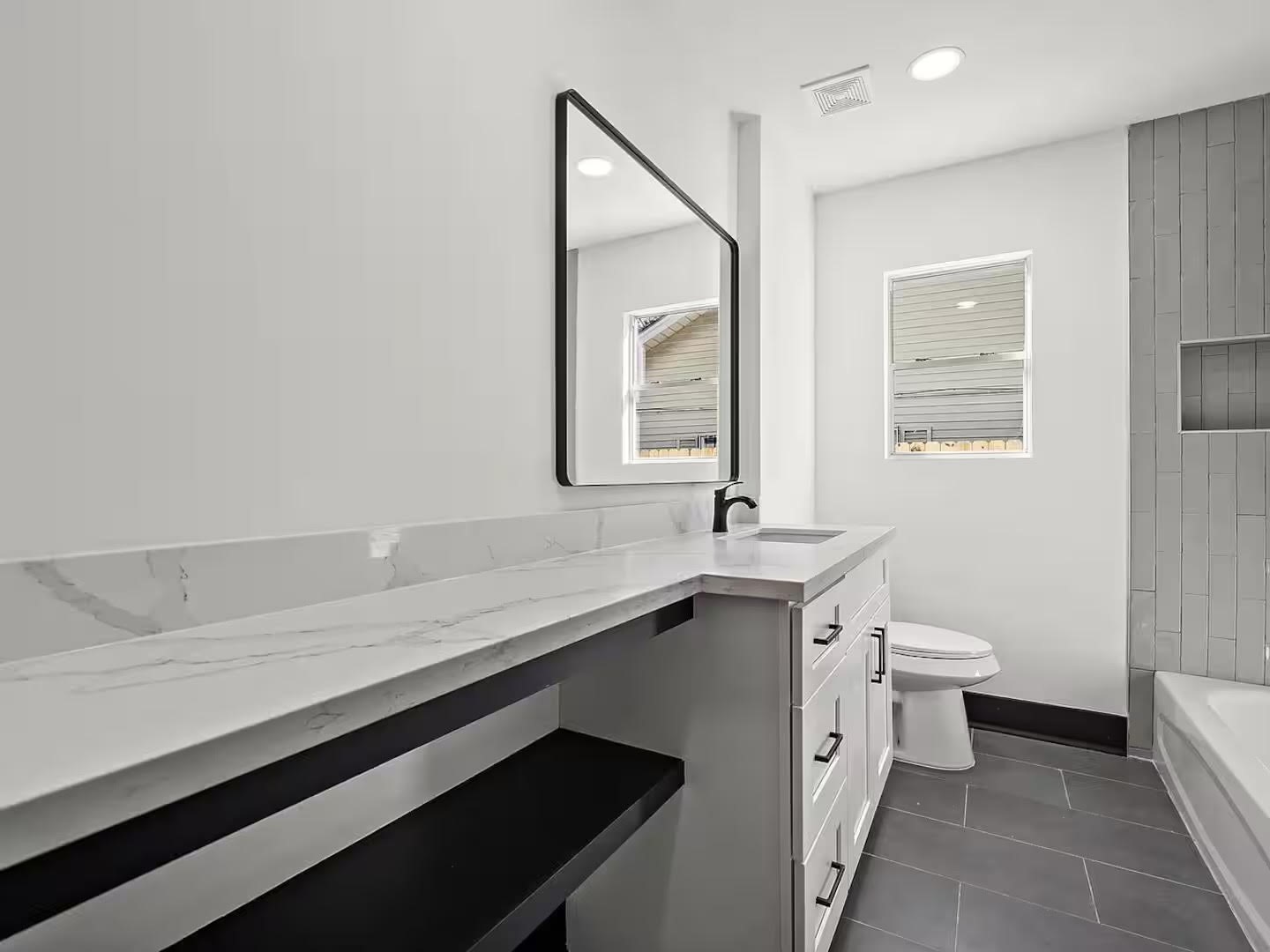 6305 Gay Street Houston, TX 77022 - Photo 10 of 13 a bathroom with a sink a toilet and mirror