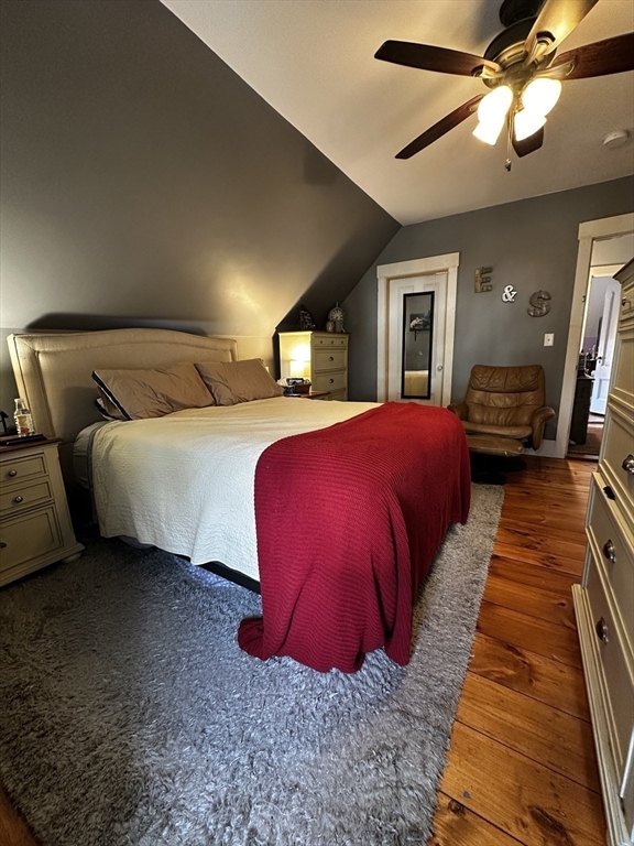 131 Pleasant Valley Street Methuen, MA 01844 - Photo 15 of 23 a bedroom with a large bed and a chandelier
