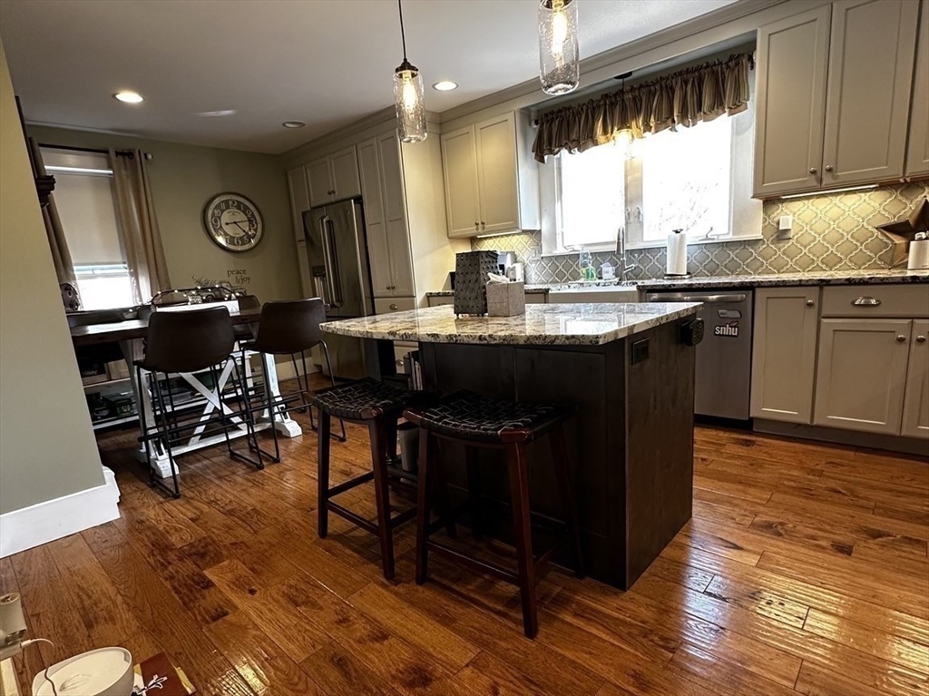 131 Pleasant Valley Street Methuen, MA 01844 - Photo 8 of 23 a kitchen with stainless steel appliances granite countertop a sink a stove and a wooden floors