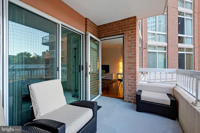 a balcony with furniture and a window
