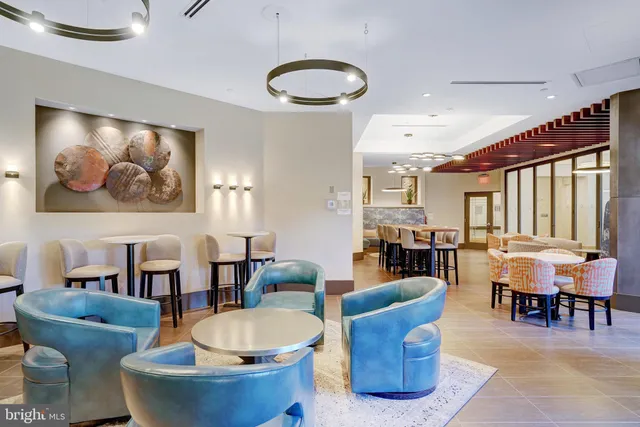 a living room with furniture a dining table and a large window