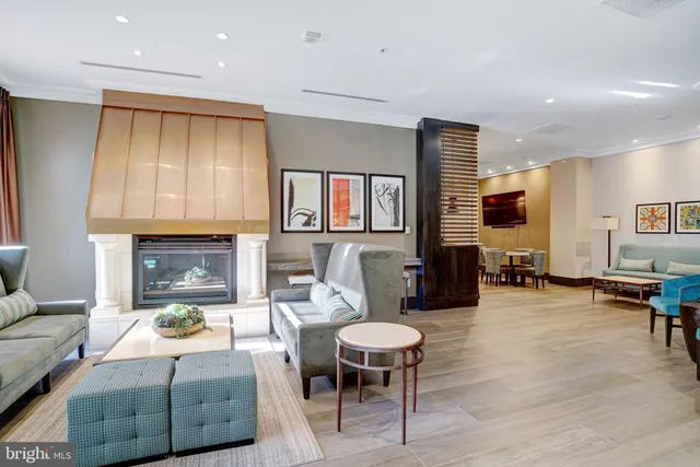 a living room with furniture a fireplace and a table