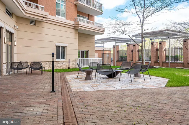 a view of a building with garden and sitting area
