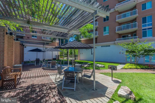 a view of a backyard with a patio and outdoor seating