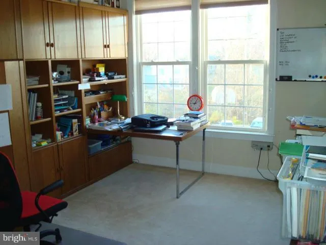 a room with furniture a window and bookshelf