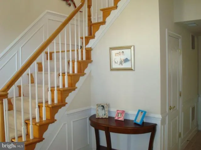a view of a hallway with an entryway and wooden floor