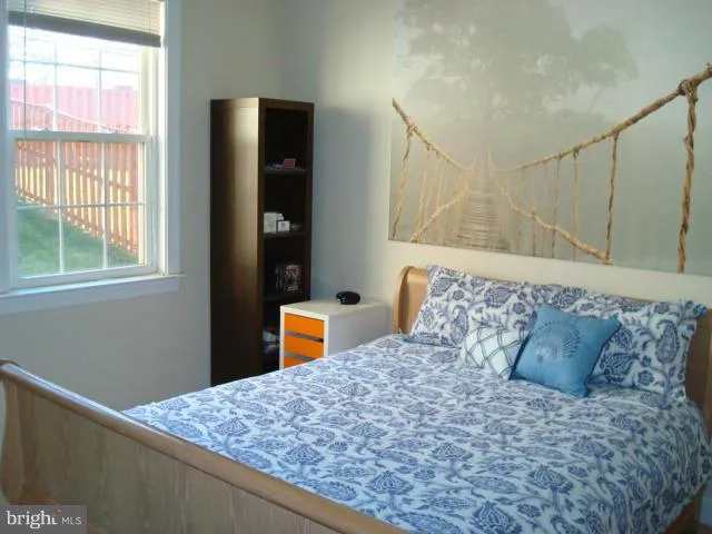 a large bed sitting in a bedroom next to a window