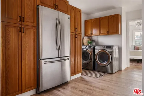 a kitchen with refrigerator a washer and dryer