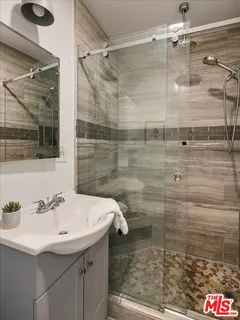 a bathroom with a shower and sink